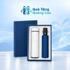 Minh họa bình trắng 500ml và dù gấp ba màu xanh nằm trong hộp xanh khay sáng