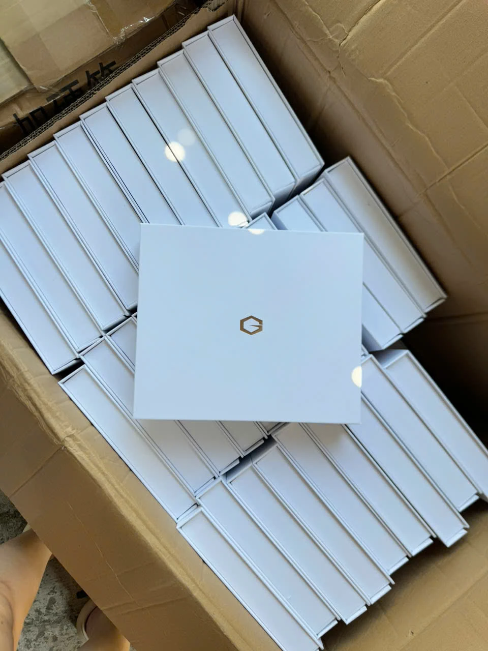 Các hộp quà trắng xếp trong một thùng carton ngoài
