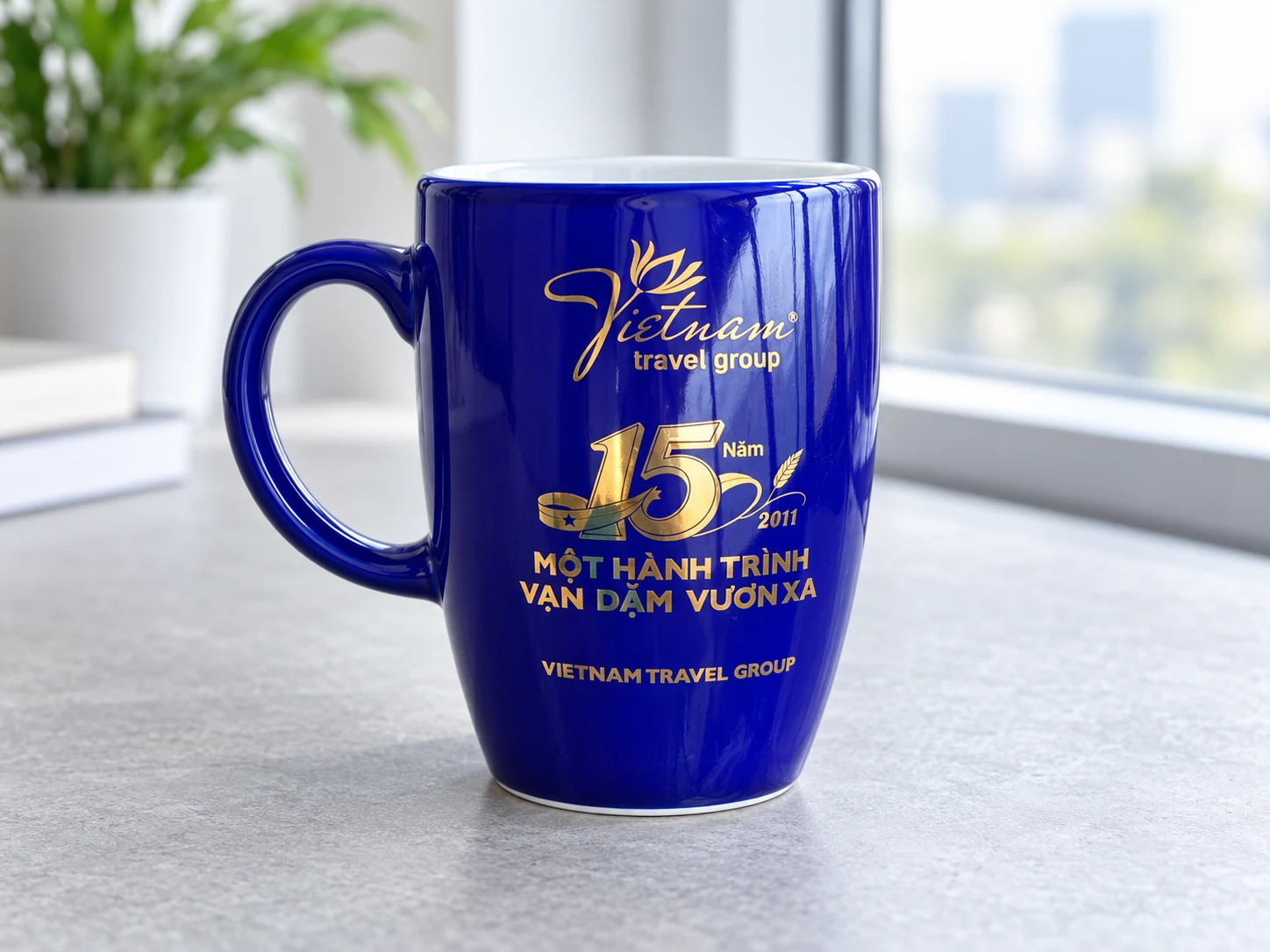 Cốc xanh có mốc kỷ niệm và thông điệp in màu vàng